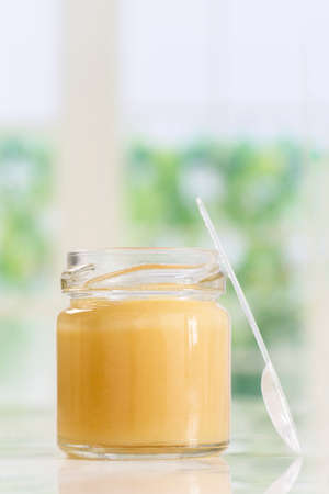 raw organic royal jelly presented in a small bottleの写真素材