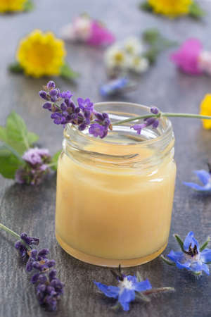 raw organic royal jelly in a small bottle on slate boardの写真素材