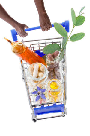 Hands pushing supermarket trolleys filled with pills and medicinal treatmentの写真素材
