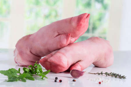 Raw pork legs with parsley on a white background