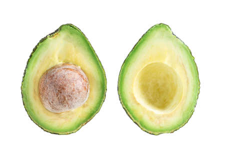Two slices of avocado . One slice with core.