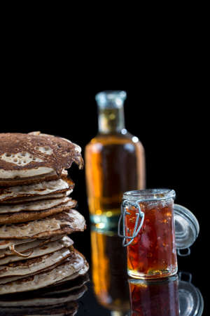 Glutten-free pancakes with jam and Maple syrup, bio healthy ingredients, on blackの写真素材