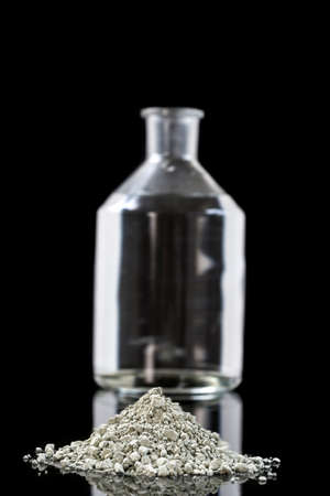 Spa background with Clay in pieces and bottle of water, ready ingredient for mask and skincare...