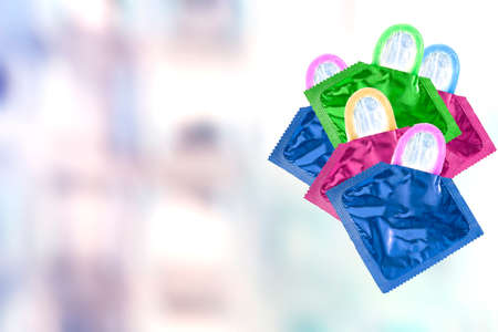 Close up shot of various colored condoms in blurry backgroundの写真素材