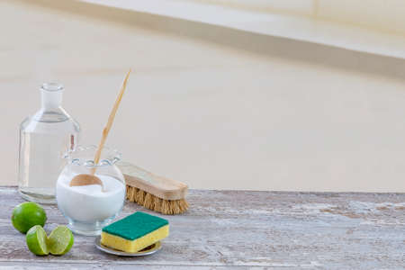 Eco-friendly natural cleaners baking soda, lemon and cloth on wooden table background,の写真素材