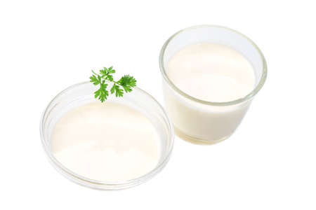 close up of two sour cream pot with parsley in on white background top viewの写真素材