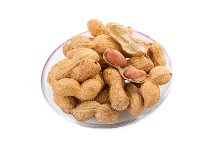 peanuts in glass bowl on white background