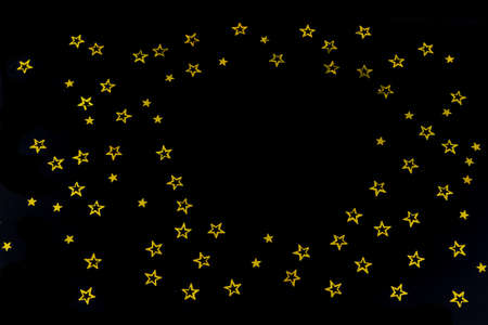 background of golden glitter particles stars on black background,happy with copy space on the middle