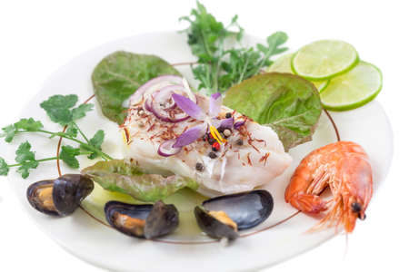 Cod fish fillet, Atlantic cod with seafood mussells,shrimps,lime and vegetable, on white background