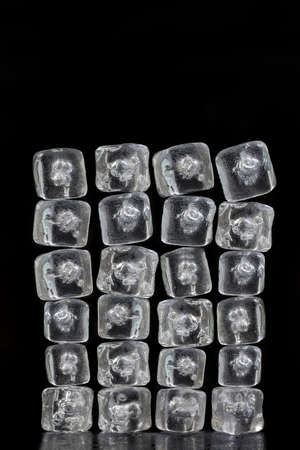 vertical texture background pile of ice cubes reflection on blackの写真素材
