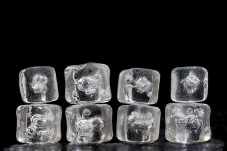 horizontal texture background pile of ice cubes reflection on black, copy space