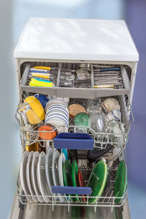 Open dishwasher with clean glass and dishes, selective focus, Clean after washing in the dishwasher. bright colorful dishes.の写真素材