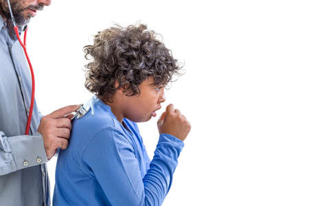 young boy flu. doctor examines a young teen boy colds listen to the lungs with a stethoscope while he is ccoughingの写真素材