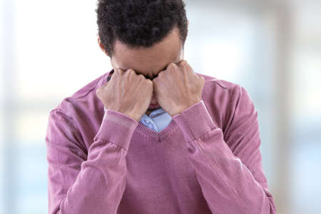 Young man suffering depression feeling sorrow and pain in human emotions facial expressions.