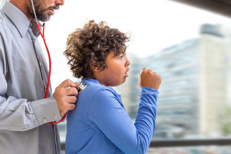 Male doctor listening boy back with stethoscope Bay window ackgound