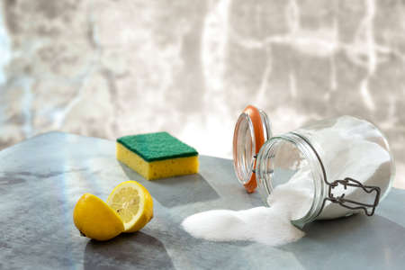Lemon and sodium bicarbonate. Eco-friendly natural cleaners baking soda, lemon on wooden tableの写真素材