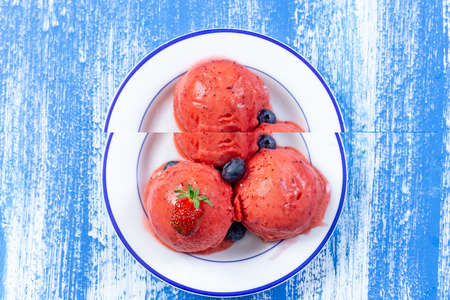 plate of pink strawberry ice cream frresh berry znd mint isolated on whiteの写真素材