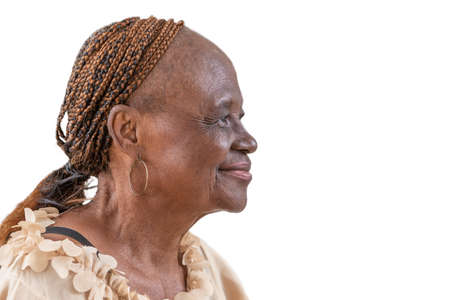 A close-up of an elderly black woman looking happy and gracefull and a nice smile on whiteの写真素材