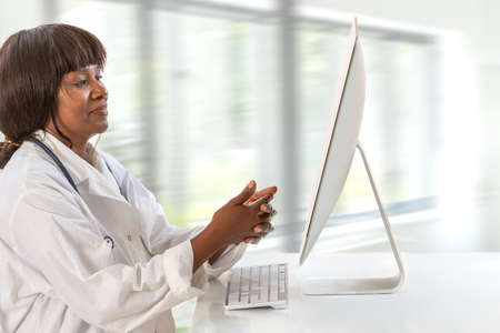 Tech,ology and patient care-doctor in front of a empty monitor, concept telemedicine and e-health.の写真素材