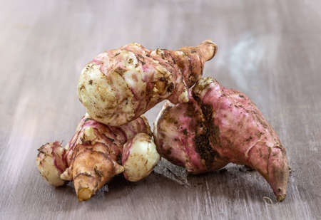 Jerusalem artichoke vegetables, isolated over white background with reflection. Helianthis tuberosus.の写真素材
