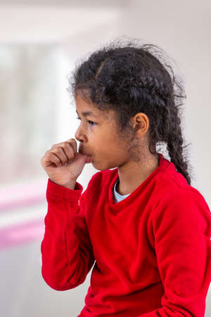 Little girl sucking her thumb.の写真素材