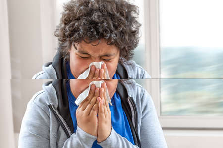 Child cold flu illness tissue blowing runny nose.の写真素材