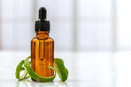 Lemon essential oil on a wooden background. medicine.の写真素材