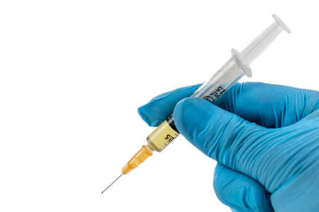 Gloved hands holding a syringe dose. Concepts of medical treatment, epidemic or vaccineの写真素材