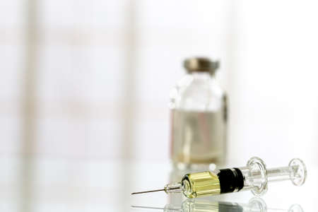 Medicine bottles glass and syringe injection needle on white background - Medication drug bottle equipment medical tool for nurse.の写真素材