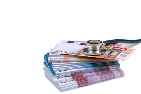 a stethoscope on a wad of euro bills, depicting the concept of the health care costsの写真素材