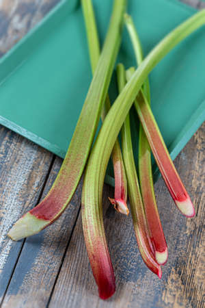 Bunch of fresh rhubarb on wooden background