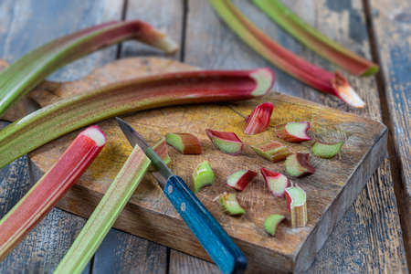 Bunch of fresh rhubarb on wooden backgroundの写真素材