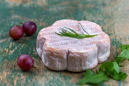 French Saint Albray cheese, honey and grapes on wooden board, rustic styleの写真素材