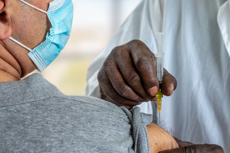 Coronavirus or other disease vaccination to male patientの写真素材