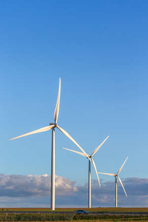 wind mill or also wind-turbine on wind farm in rotation to generate electricity energy