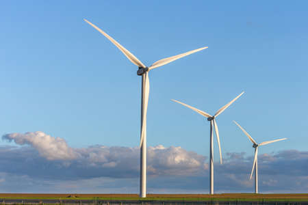 wind mill or also wind-turbine on wind farm in rotation to generate electricity energyの写真素材