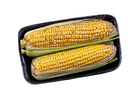 Packaged and sealed fresh grocery store yellow corn. Isolated. on whiteの写真素材