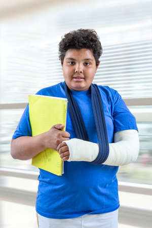 Child with broken arm in school Isolated on white backgroundの写真素材