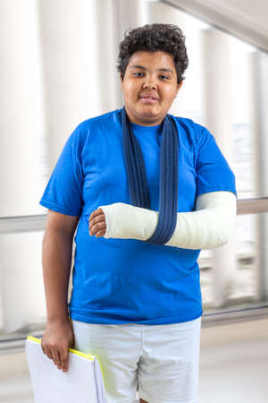 child, arm in plaster, school,, studio shoot. Isolated on whiteの写真素材