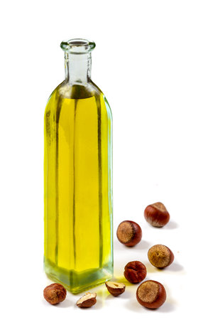 hazelnut ottle of oil with fresh hazelnuts arroundの写真素材
