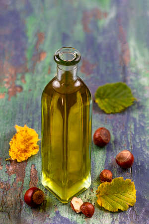 hazelnut ottle of oil with fresh hazelnuts arroundの写真素材
