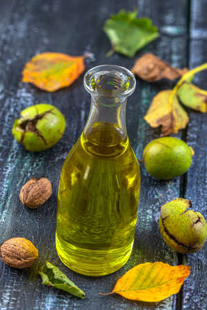 Walnut oil- bottle of walnut oil with freh walnuts aroundの写真素材