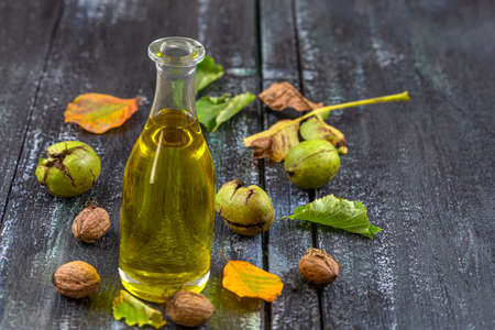 Walnut oil- bottle of walnut oil with freh walnuts aroundの写真素材