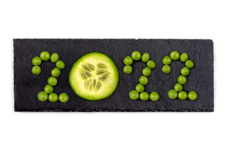 Vegan greetings 2022- Written WITH VEGETABLES ON BLACK SLATEの写真素材
