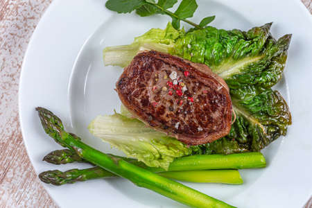 Plate of a grilled Tournedos green asparagus.