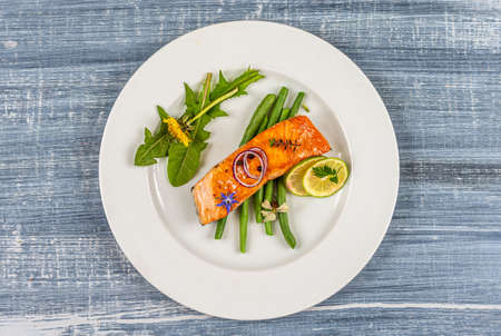 Salmon with green beans and edible flowers, and arugula