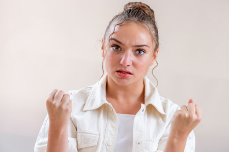 Young woman with a bun, clenched fistsの写真素材