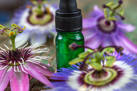 Passion flower with aromatherapy essential oil blue glass dropper bottle, isolated over white background.の写真素材