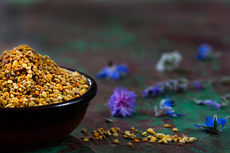 healthy bee pollen grains on wooden backgroundの写真素材