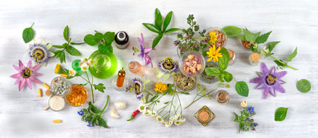 Passionflowers around bottles of vegetable oil, cosmetics, capsules, food supplements-Top viewの写真素材